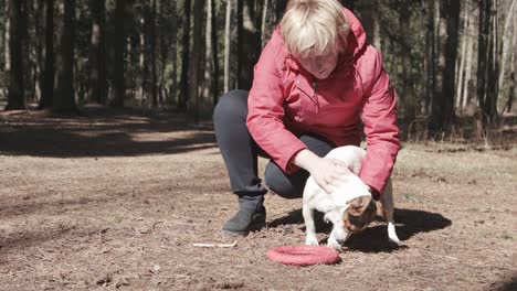 woman playing with her dog at outdoor park