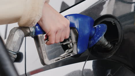 man refuels his car at a gas station 02