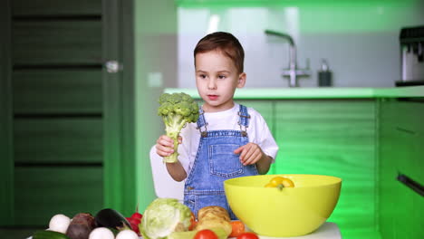 child preparing healthy meal in kitchen. a child holds broccoli in a bright kitchen, surrounded by veggies, promoting healthy eating