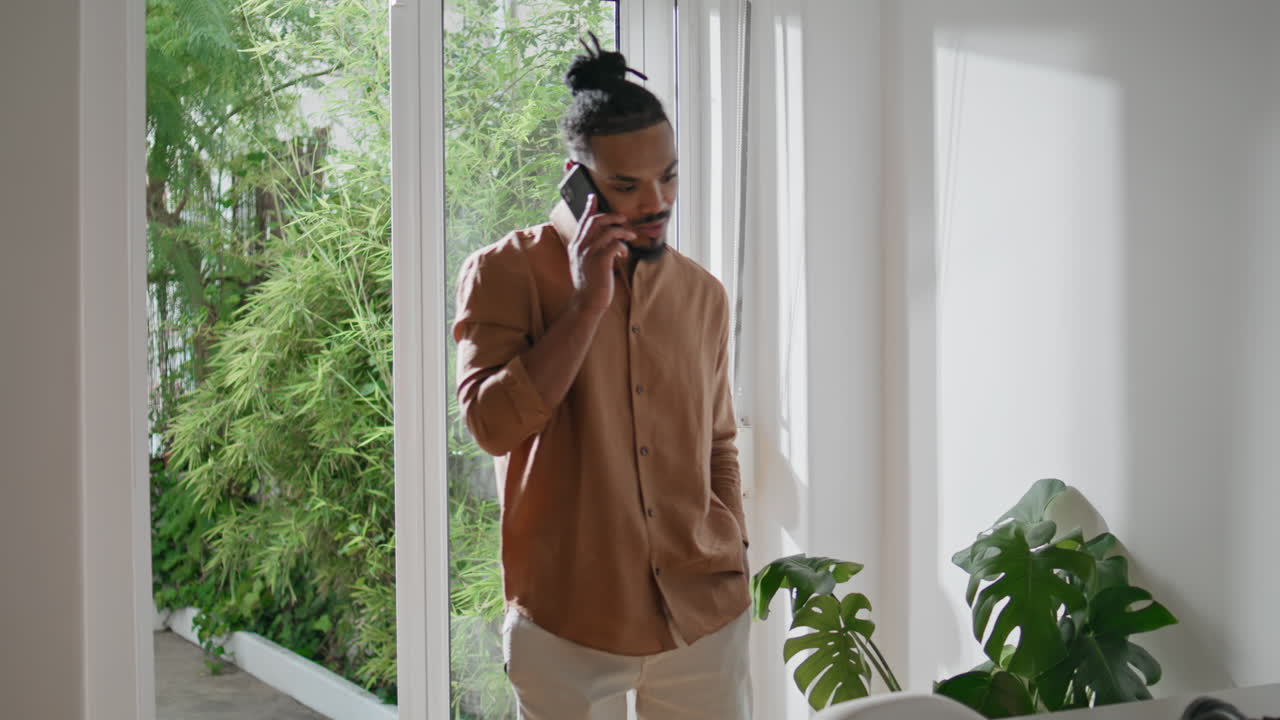 Confident man talking phone at home closeup. Successful guy having conversation