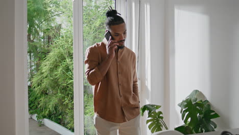 confident man talking phone at home closeup. successful guy having conversation