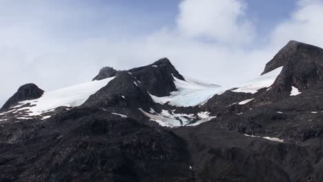 peak of the mountain covered by snow in glacier bay national park and preserve, alaska