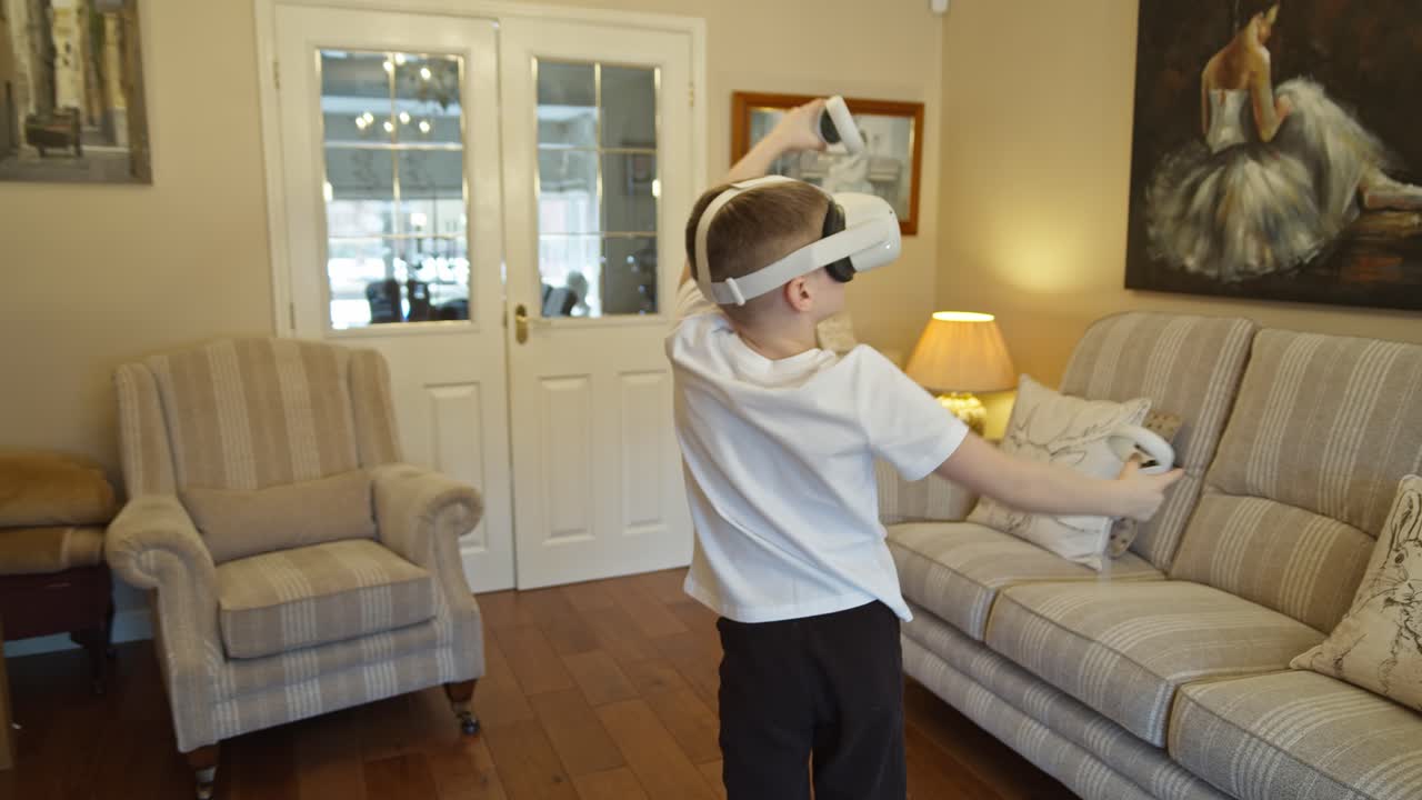 Boy playing and interacting with futuristic virtual reality game and goggles at home