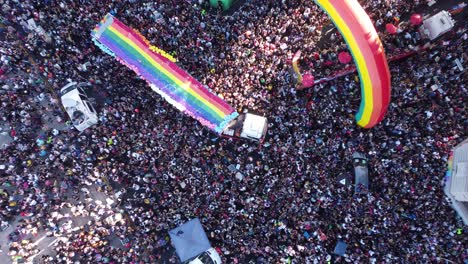 rainbow colored flags during lgbt pride parade in buenos aires - aerial top down