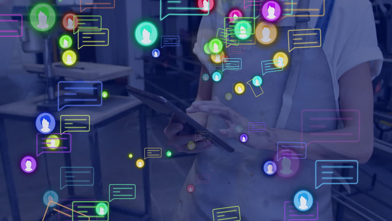 Colorful chat bubbles and user icons animation over person using tablet in office
