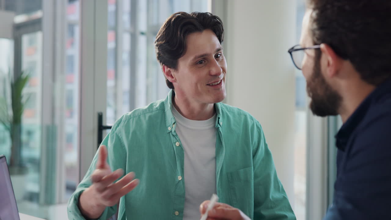Two men discussing business in an office