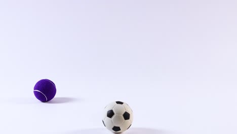 various balls bouncing and rolling on white surface