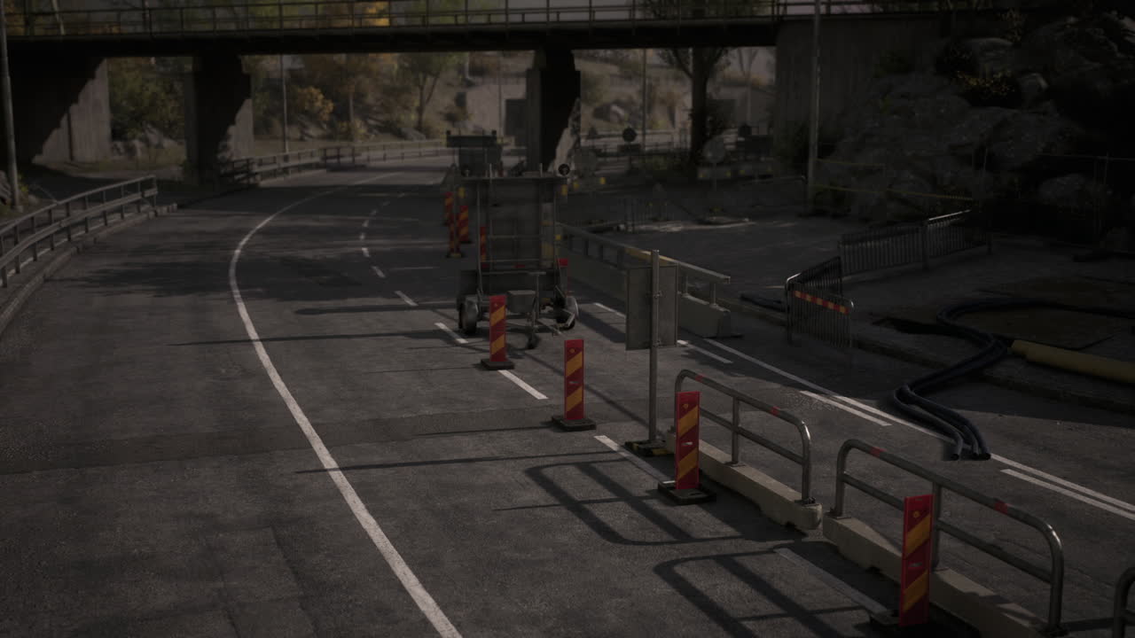 Abandoned roadway with construction barriers and heavy machinery