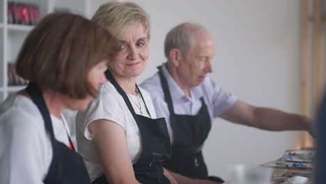 elderly men and women share their impressions of the drawing courses. emotions of a senior people talking together. activities for older friends