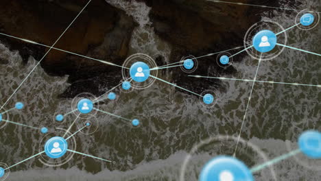 network of connections and data processing animation over ocean waves and rocks