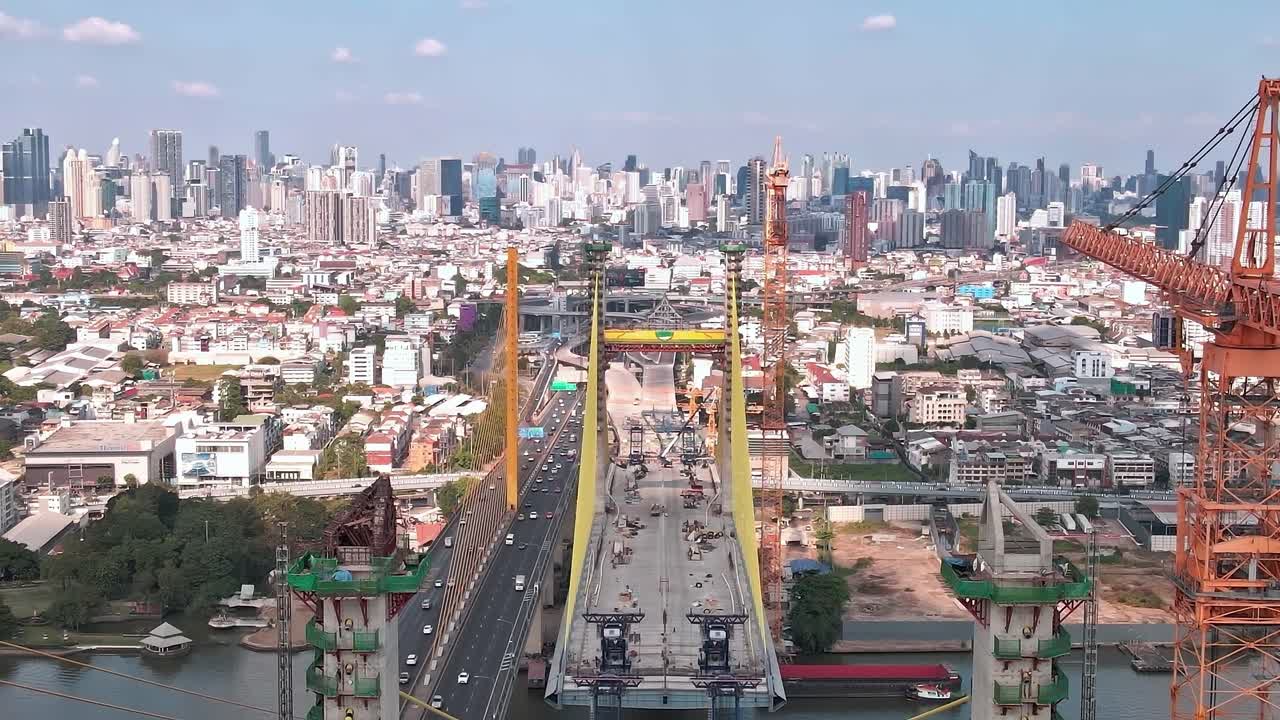 Construction progress on a new bridge in Bangkok near city skyline