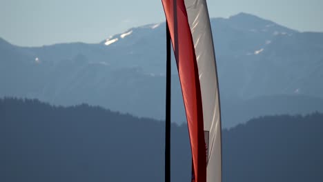 red and white south tyrol (italy) flag in front of the dolomite mountains