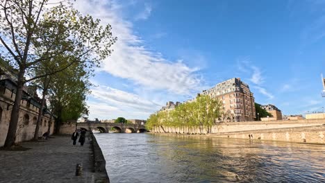 people walking by the seine river in paris