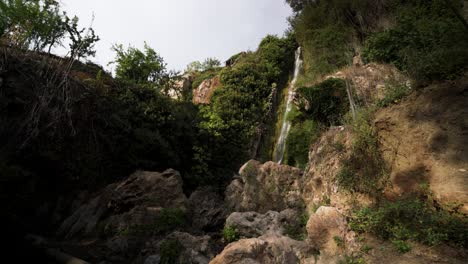 Water-stream-falling-down-rocky-mountain-in-Spain,-static-view