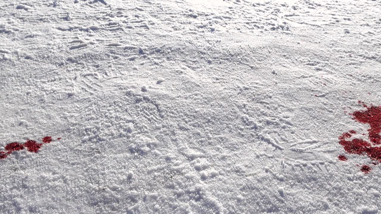 Ground level move passes between numbered markers beside red stain absorbed into bright snowy surface