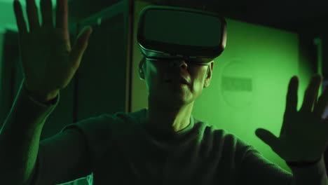 asian man wearing vr headset by computer server