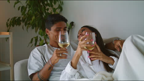 young spouses laughing hotel evening closeup. relaxed couple drinking wine home