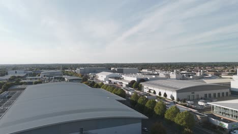 low sweeping aerial perspective of slough trading estate's industrial landscape in golden light, berkshire, uk, october 2024