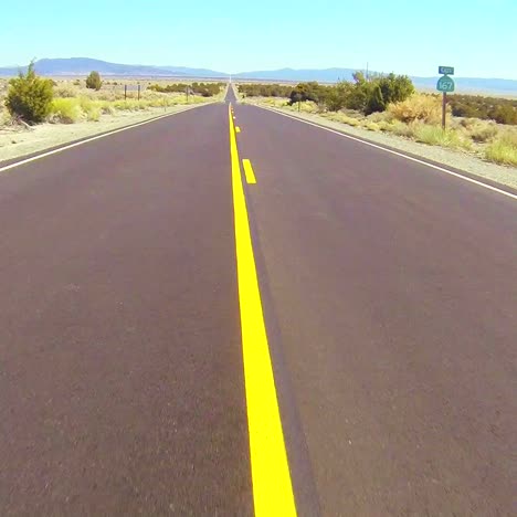 POV-shot-driving-along-a-desert-road-at-a-fast-speed