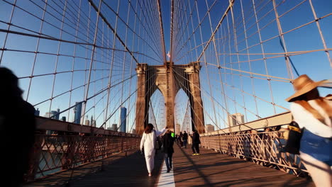 people walking on the brooklyn bridge