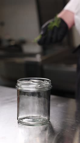 chef preparing a herb and garlic infused jar