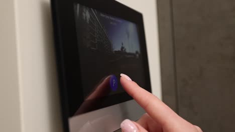 person using a modern building intercom system