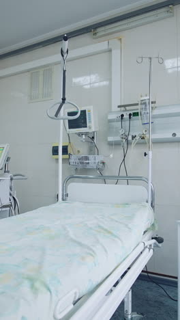 new hospital bed and equipment in a clean room. empty intensive care room. hospital bed with modern medical equipment in clinic. vertical video