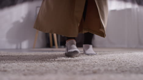 close up of muslim woman at home laying down prayer mat on floor 1