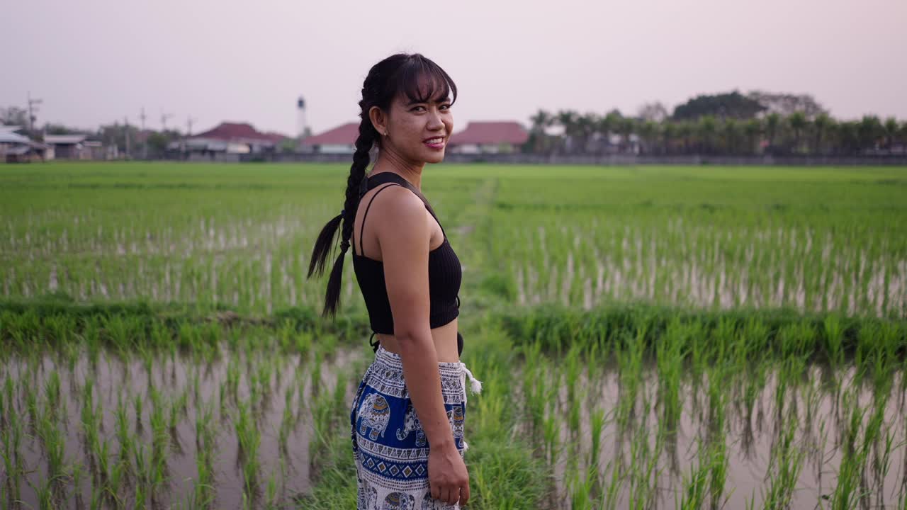 Young Woman in a Green Rice Paddy Field