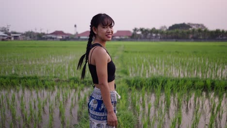 young woman in a green rice paddy field