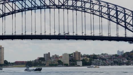 Military-naval-vessels-pass-underneath-Sydney-Harbour-Bridge-in-Australia