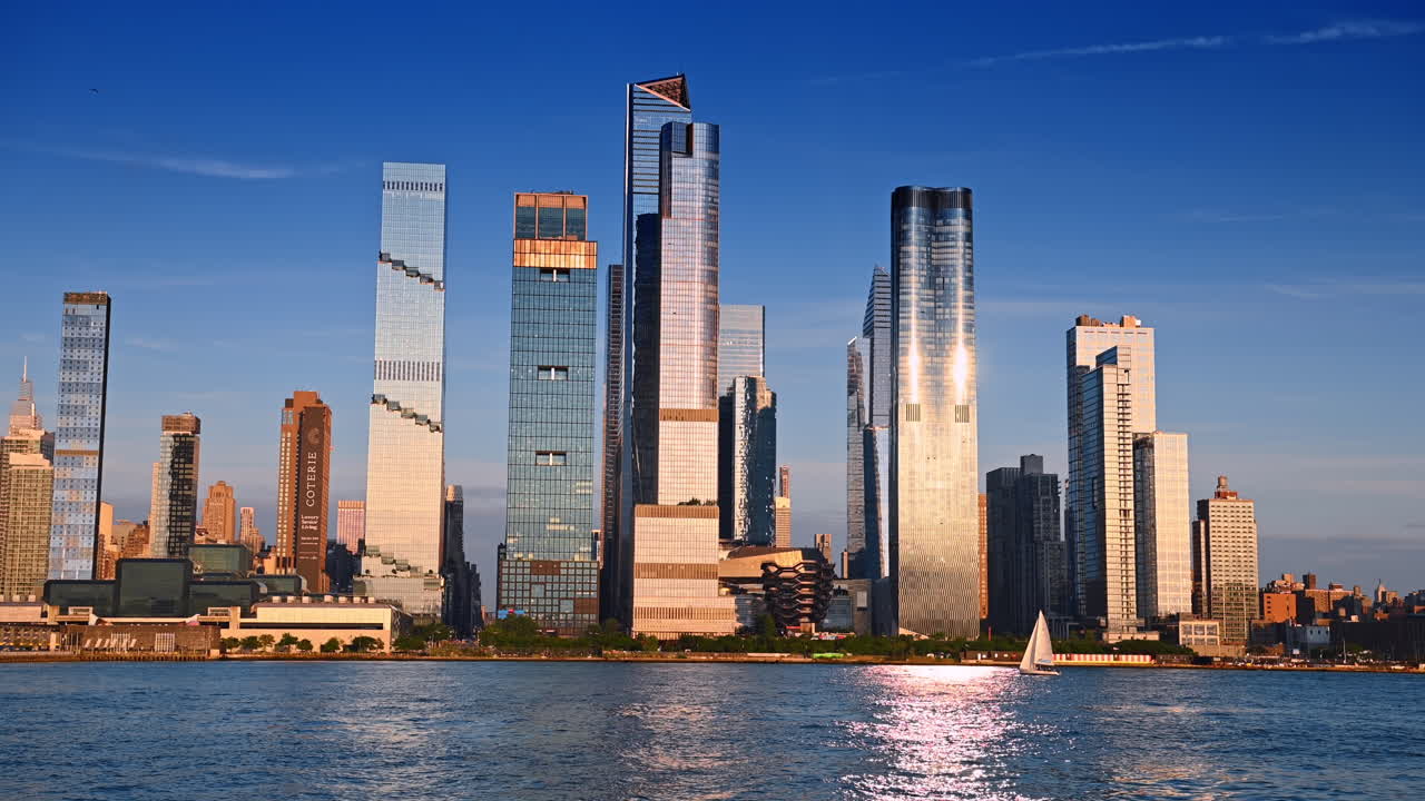 Jersey City, USA, 1 July 2025: Hudson Yards skyscrapers at sunset in New York City. Modern glass skyscrapers of Hudson Yards reflecting golden sunset light