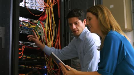 technician looking at open server locker