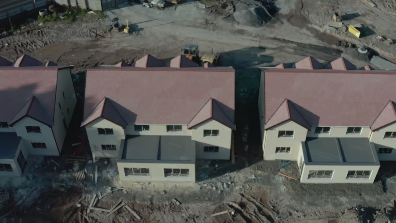 Aerial tracking shot of buildings at development construction site