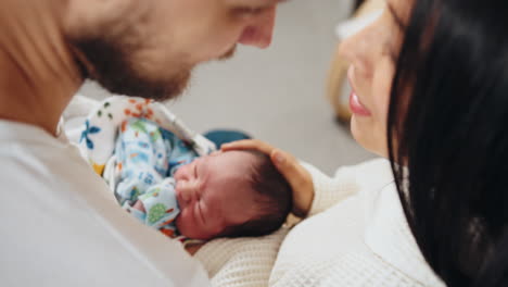 parents lovingly holding newborn baby