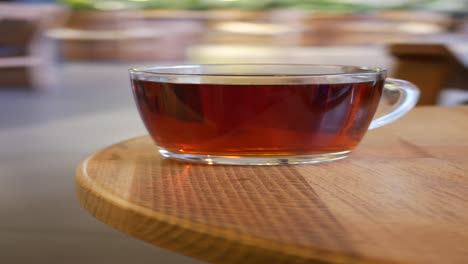 a cup of tea on a wooden table in a cafe