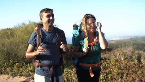 Happy-middle-aged-couple-walking-on-mountain-path