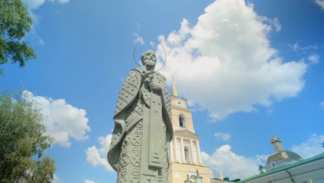 statue of a saint against a beautiful sky