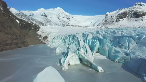 4k drone, aerial cinematic, unique shots stripped glaciers with the icelandic mountain in the background