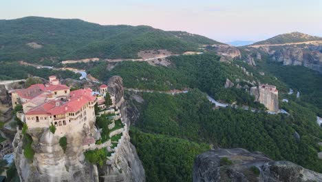 close flyby over monastery with terraces in meteora, greece, aerial