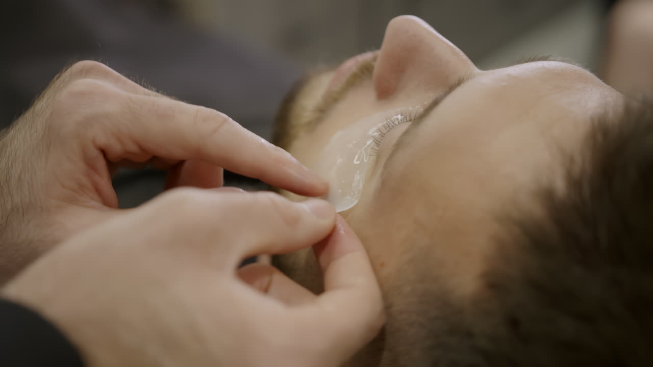 Man Receiving Under-Eye Mask Treatment
