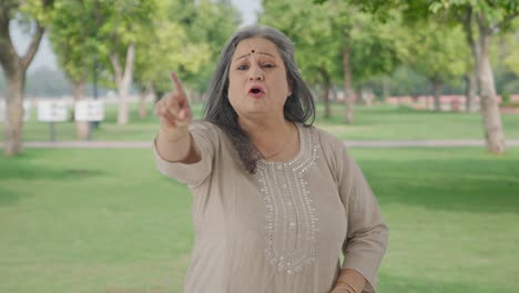 Frustrated-Indian-old-woman-shouting-at-someone-in-park