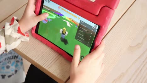 child plays roblox on her tablet