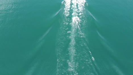 boat driving on the lago maggiore with a tube attached