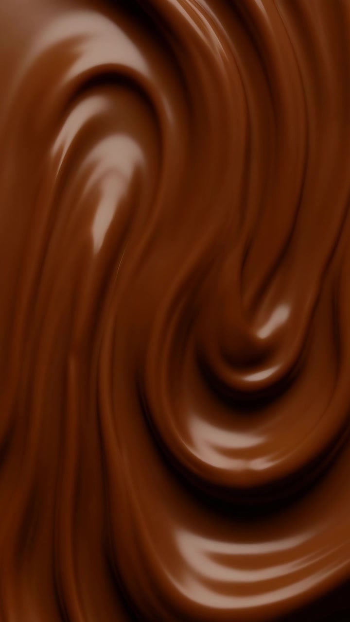 Cioccolato liquido vellutato che si avvolge al rallentatore