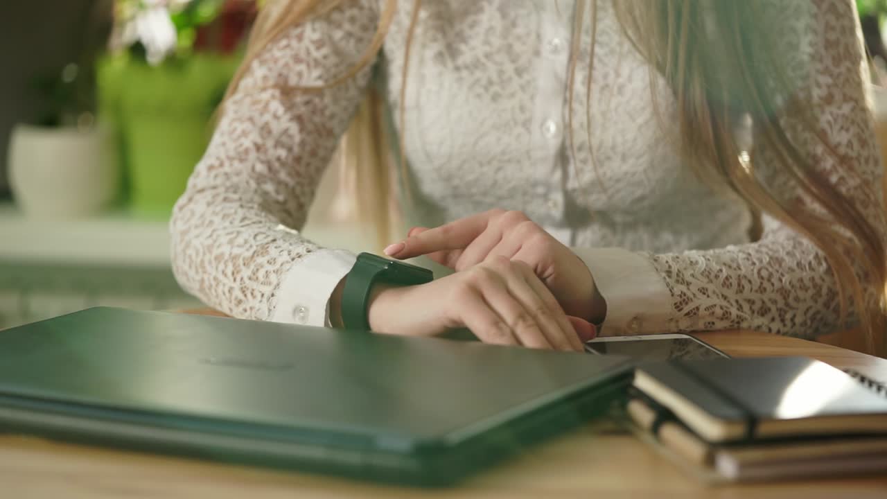 Woman checking smartwatch in office