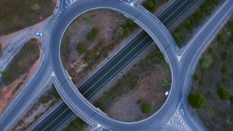 Aerial-view-in-ascent-chopped-to-general-plane-of-the-road-autovía-circle-road,-the-Dacia-Spring-2022