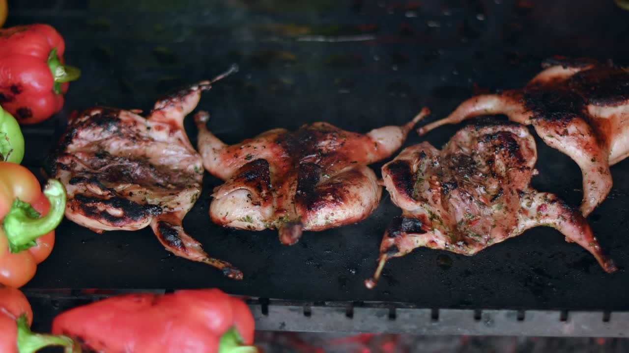 Bbq beef and quail meat on grill with vegetables