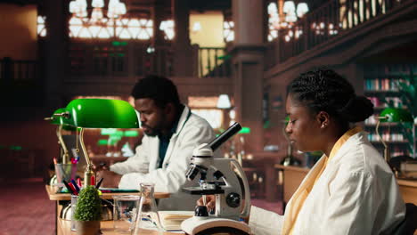 female college student focuses on medical science by using a microscope