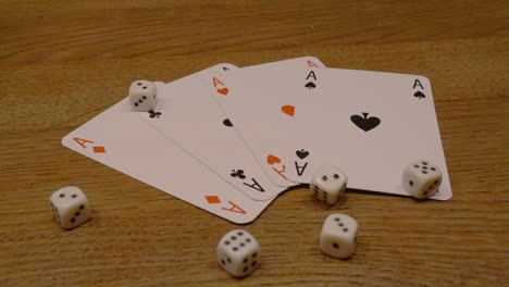 rotating close up of playing cards with playing dice on an elegant wooden table slow rotation of camera